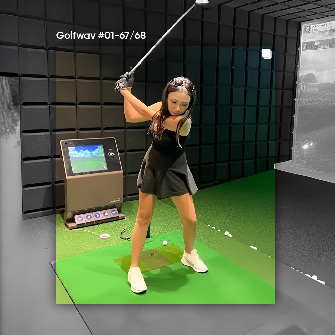 Person analyzing their swing data on an indoor golf simulator